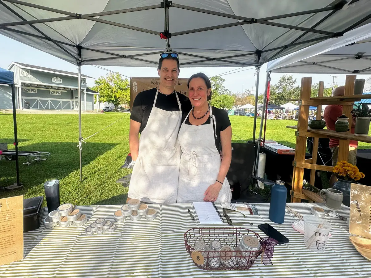 Alex Boisvert and Megan Burke at a farmers market booth